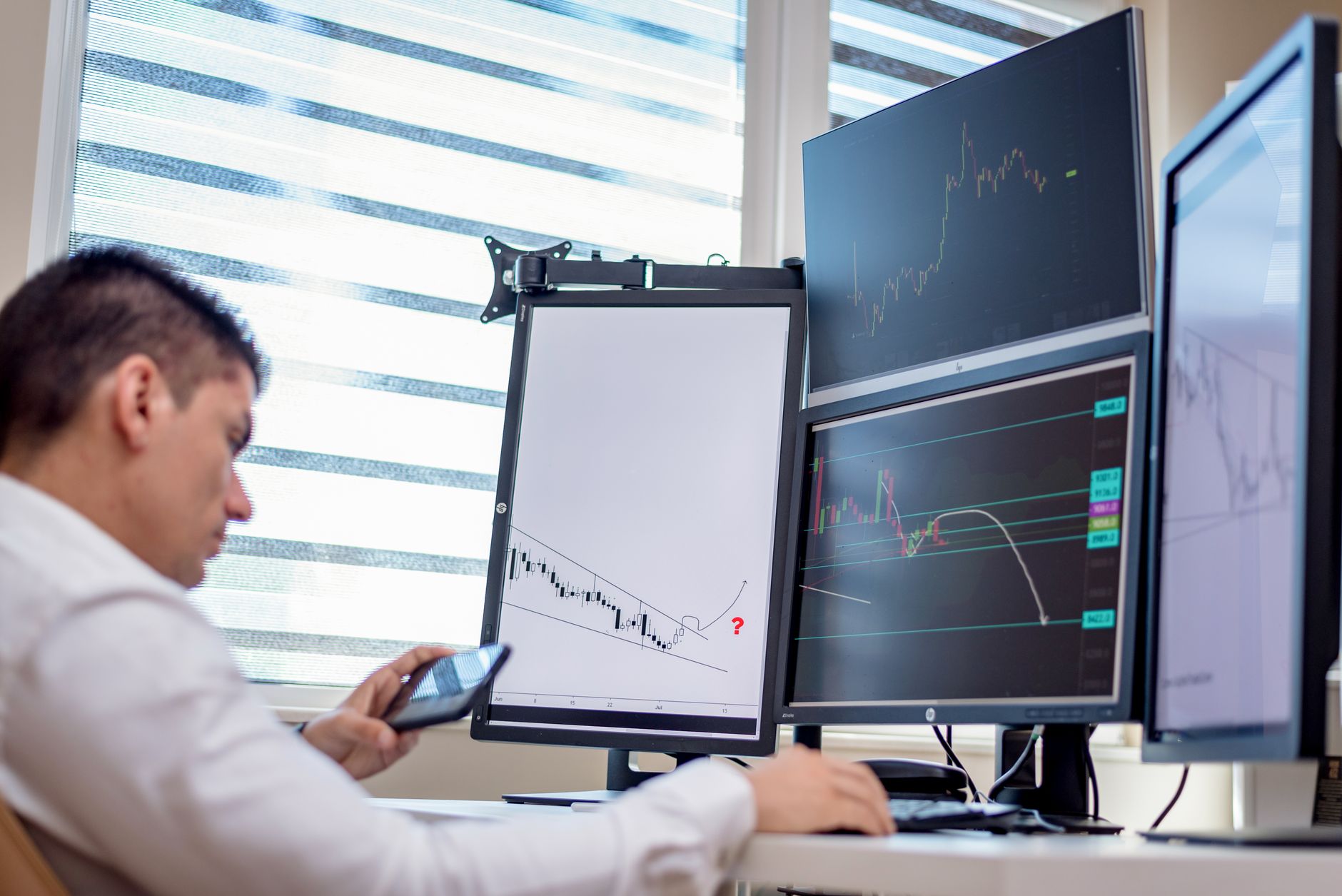 Retail trader watching financial charts on a smartphone
