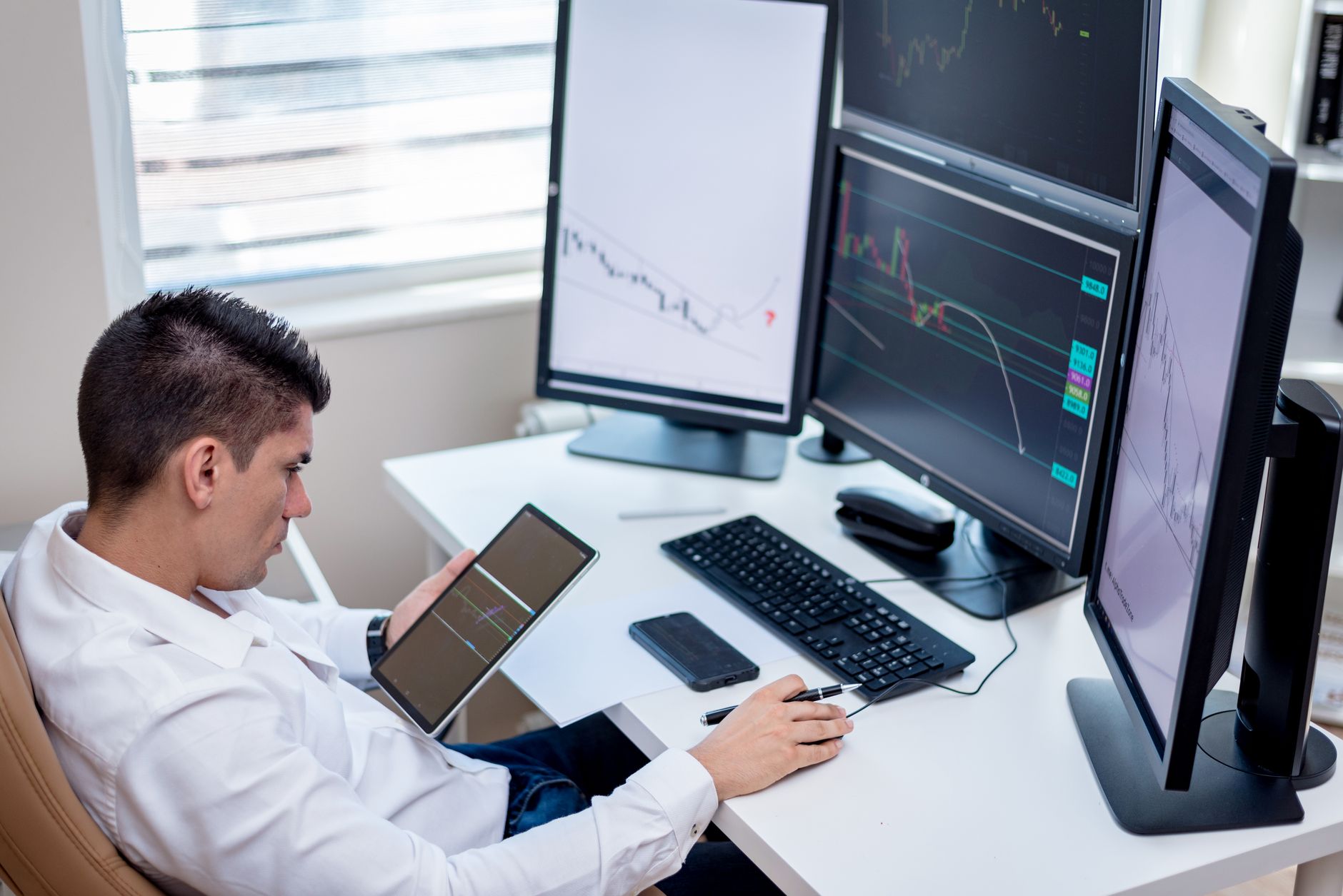 Institutional trading desk with multiple monitors displaying market activity