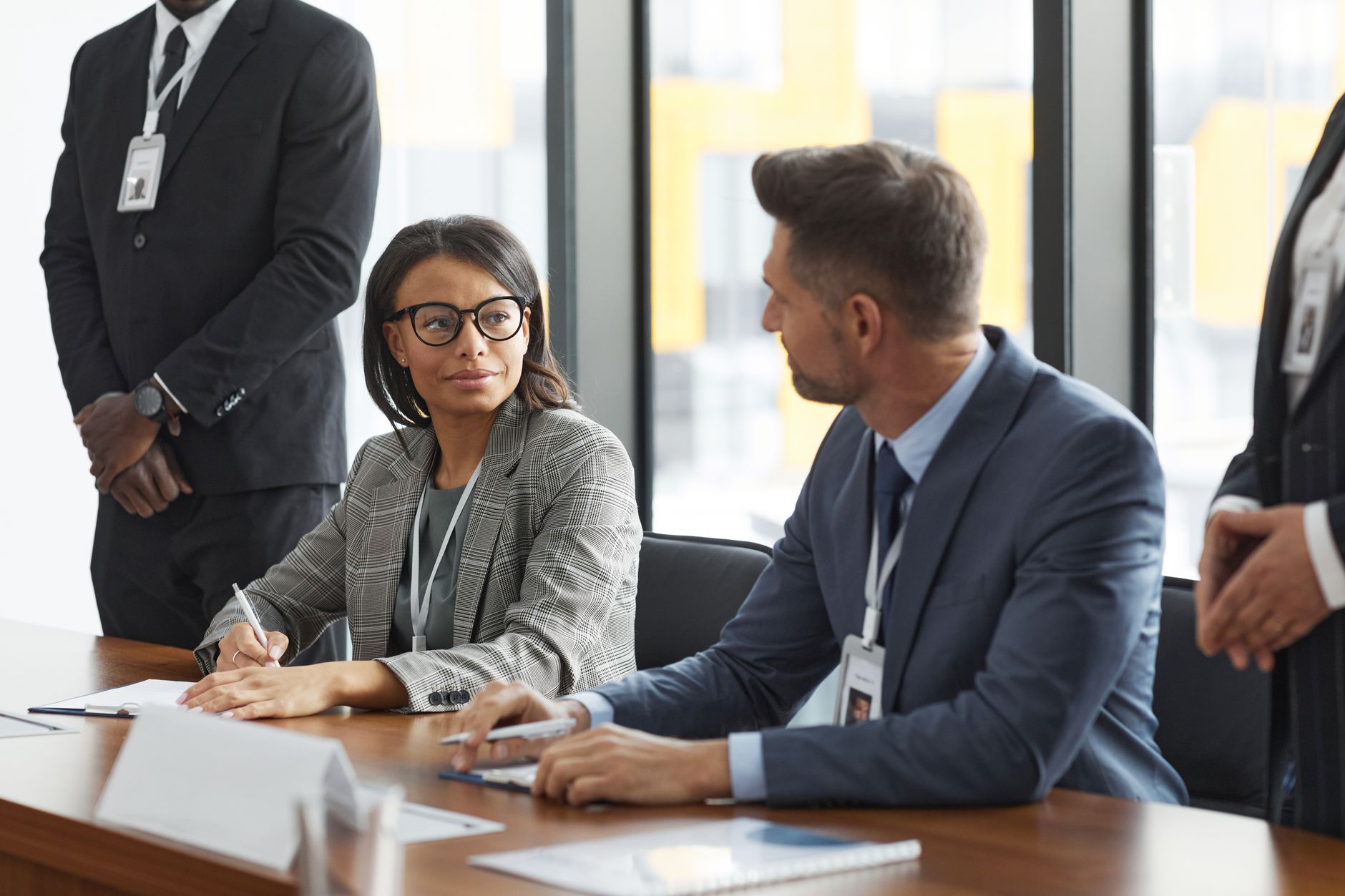 Business professionals reviewing loan documents at a conference table