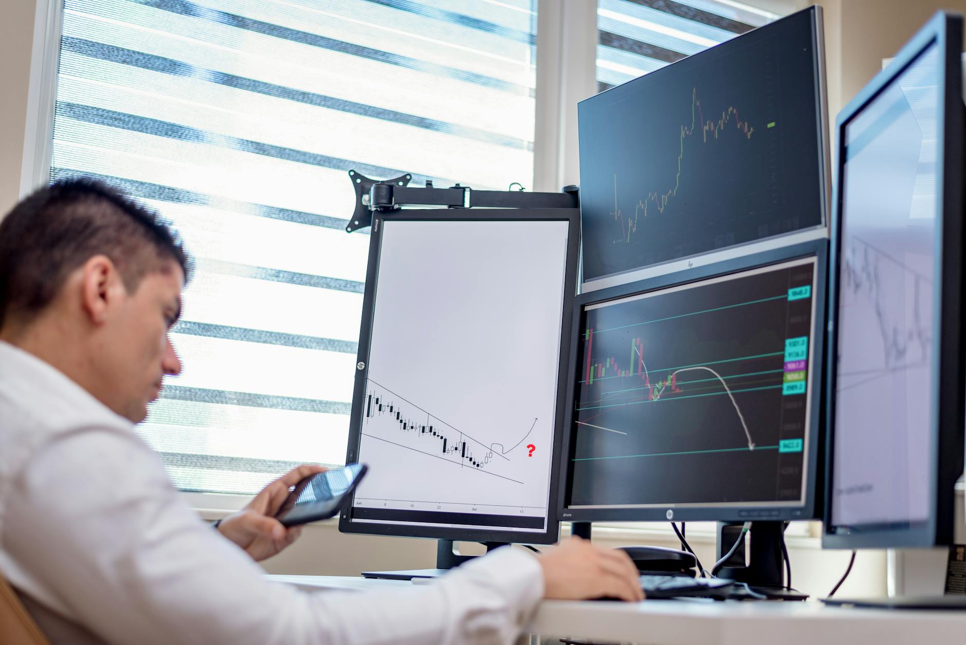 Person using a smartphone to monitor financial trading activity