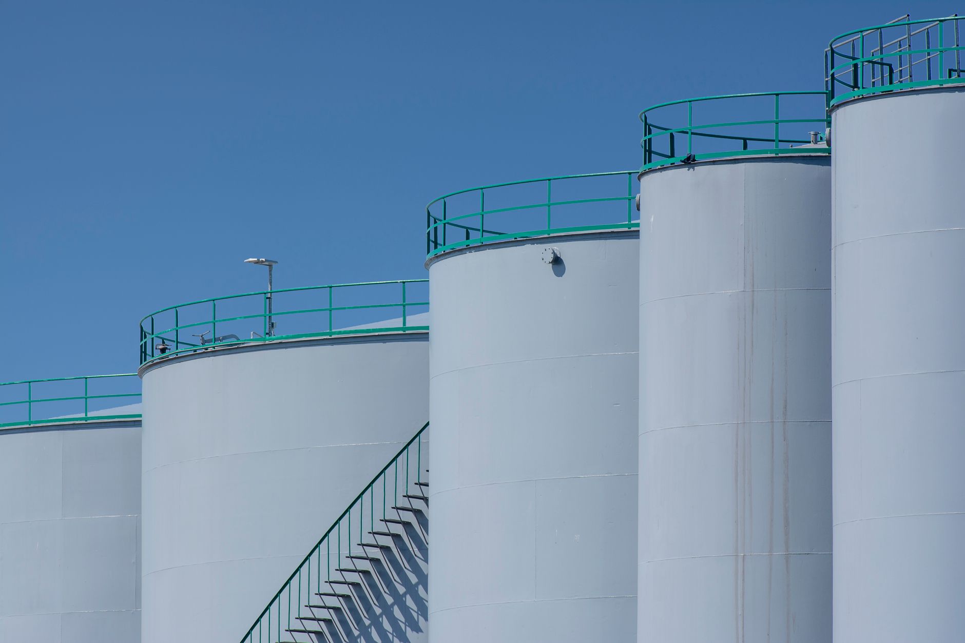 Large industrial storage tanks at an energy facility