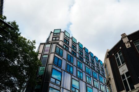 Modern commercial office building exterior reflecting financial market stress in real estate sector