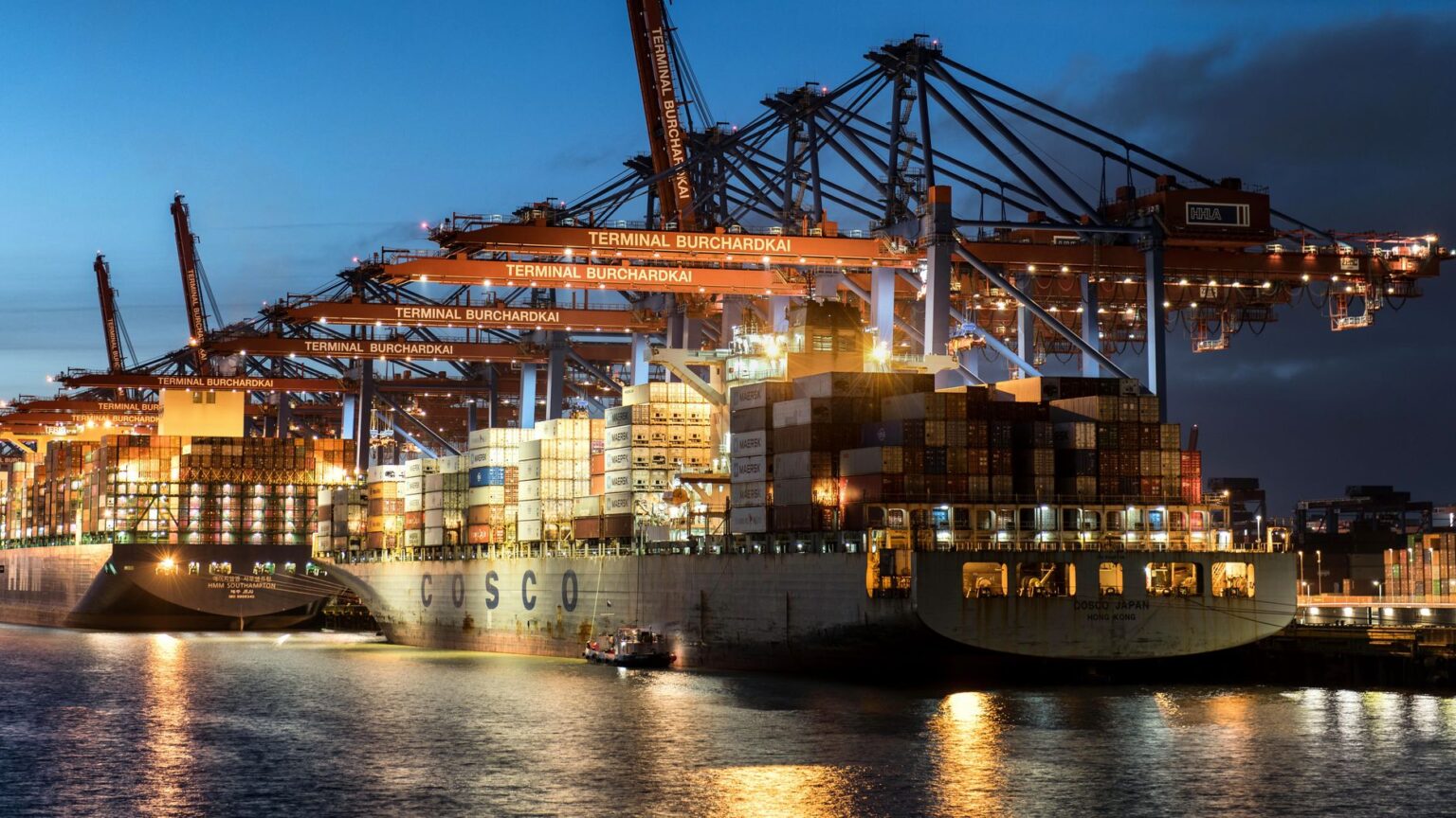 Large cargo ship docked at an industrial port, representing global commodity trade logistics