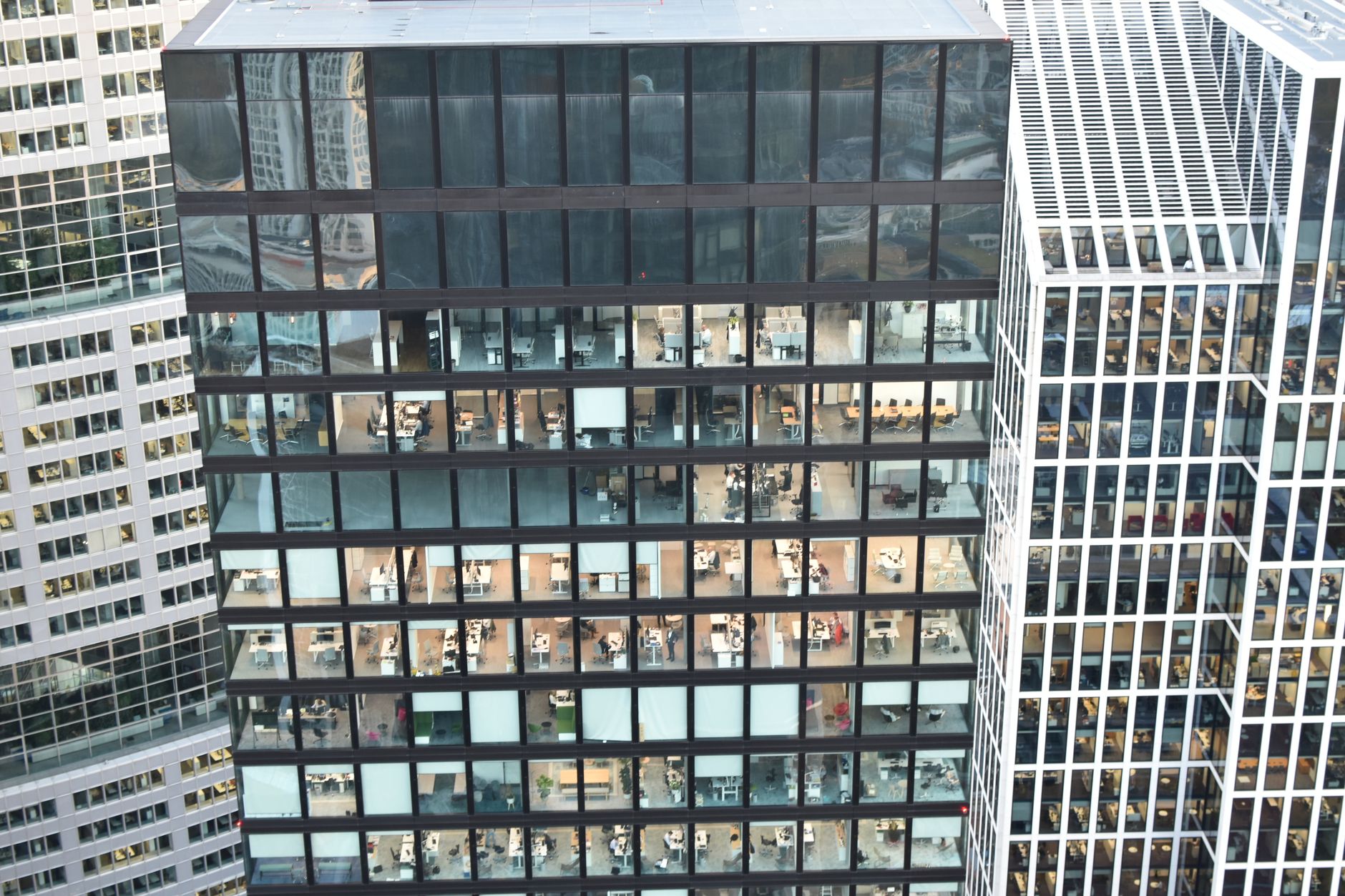 Financial professionals reviewing charts and investment data in a hedge fund office setting