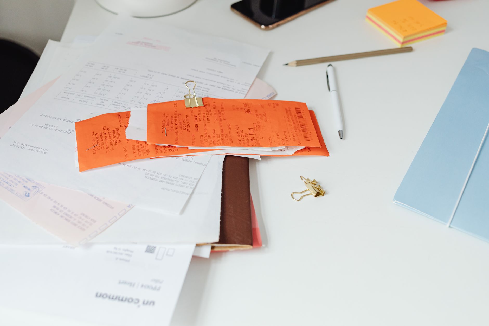 Structured finance documents and analysis materials spread across a desk during credit review