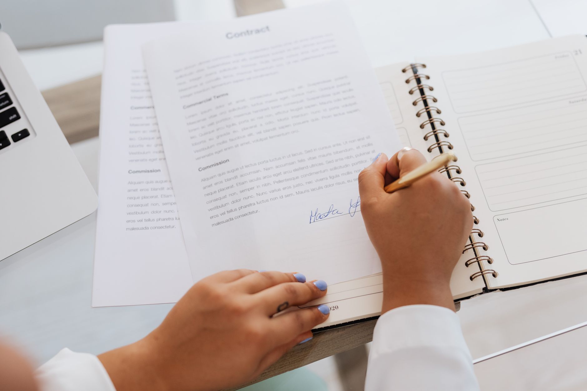 Close-up of a legal contract document with financial terms being reviewed