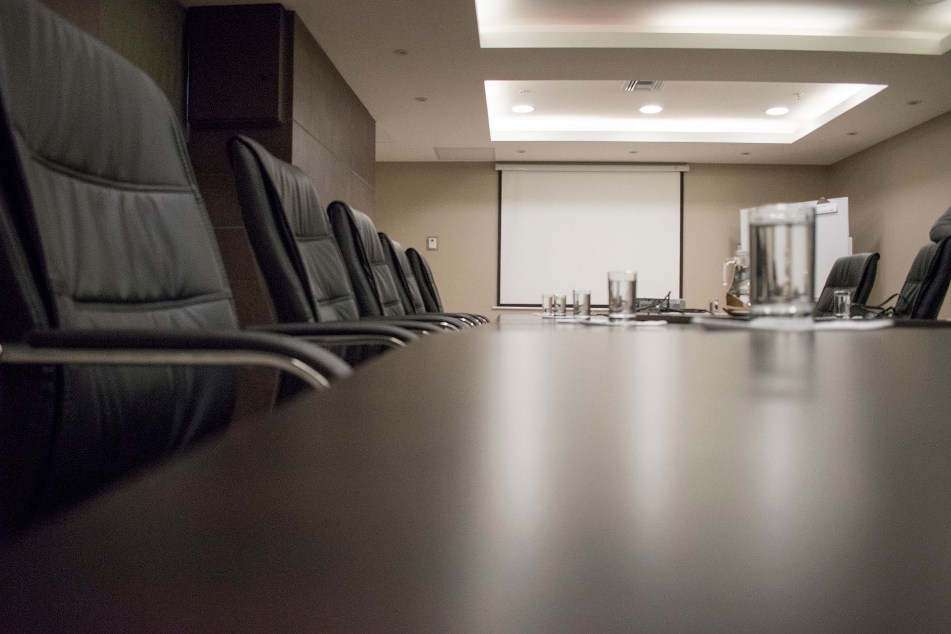 Business professionals reviewing financial documents in a corporate boardroom setting