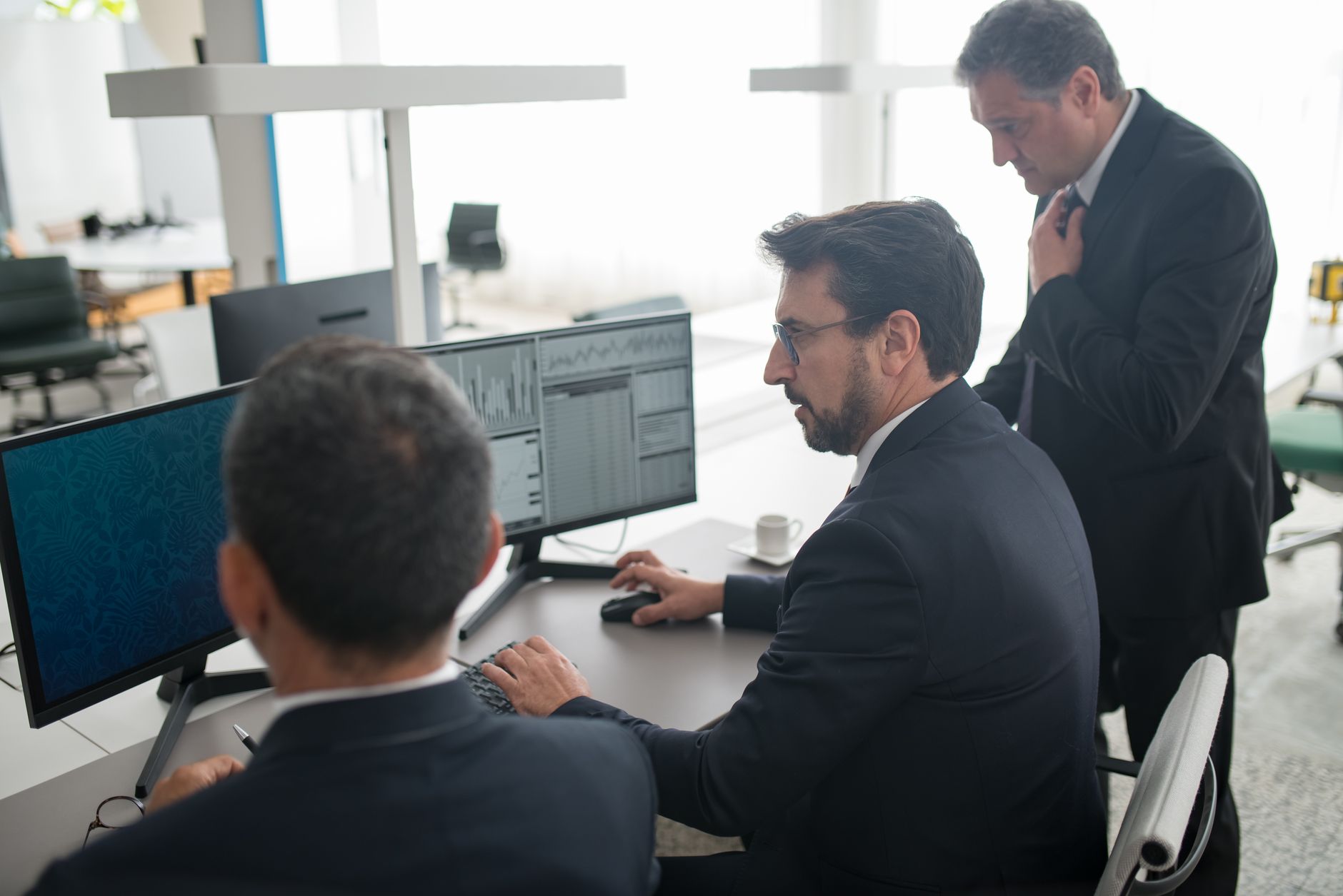 Traders working at desks in a financial trading environment