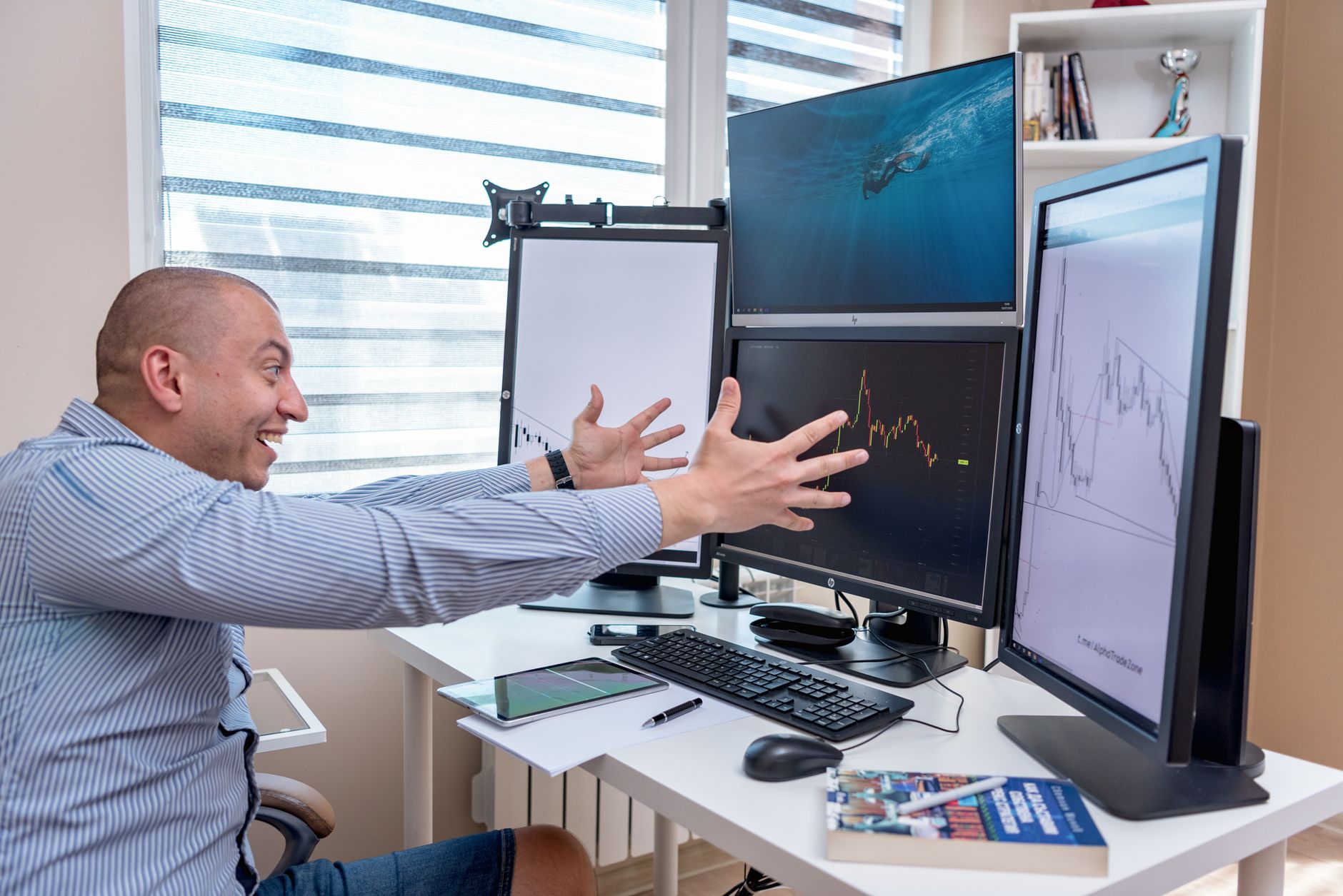 Trader at desk surrounded by monitors displaying market pricing data