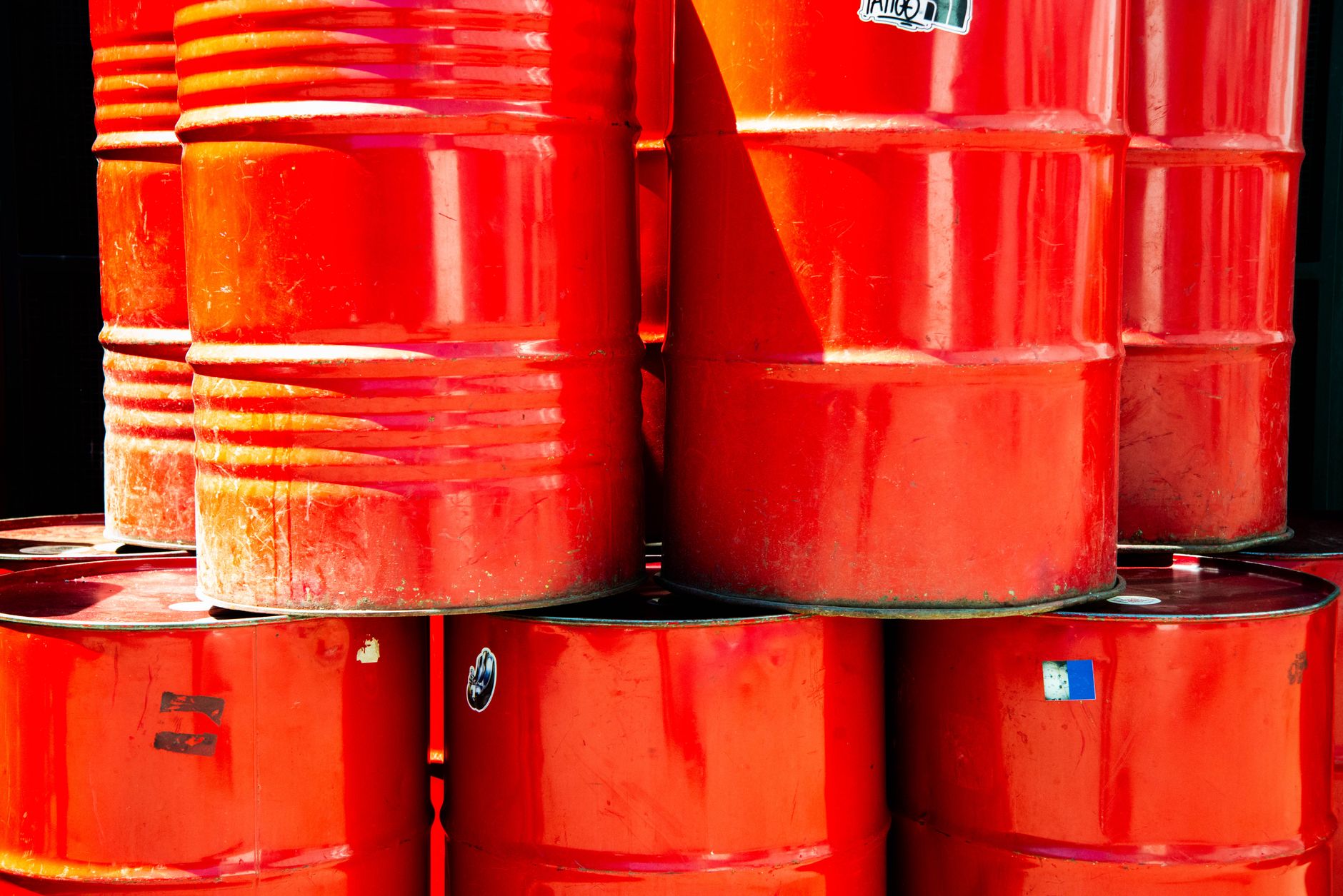 Industrial oil barrels representing energy commodity market exposure and options positioning