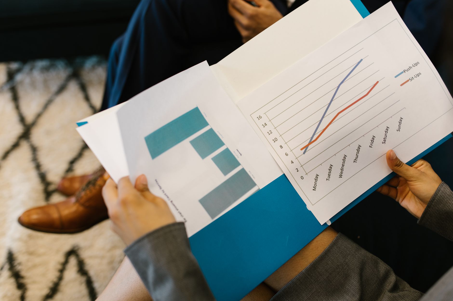 Business professionals reviewing financial documents at a meeting table