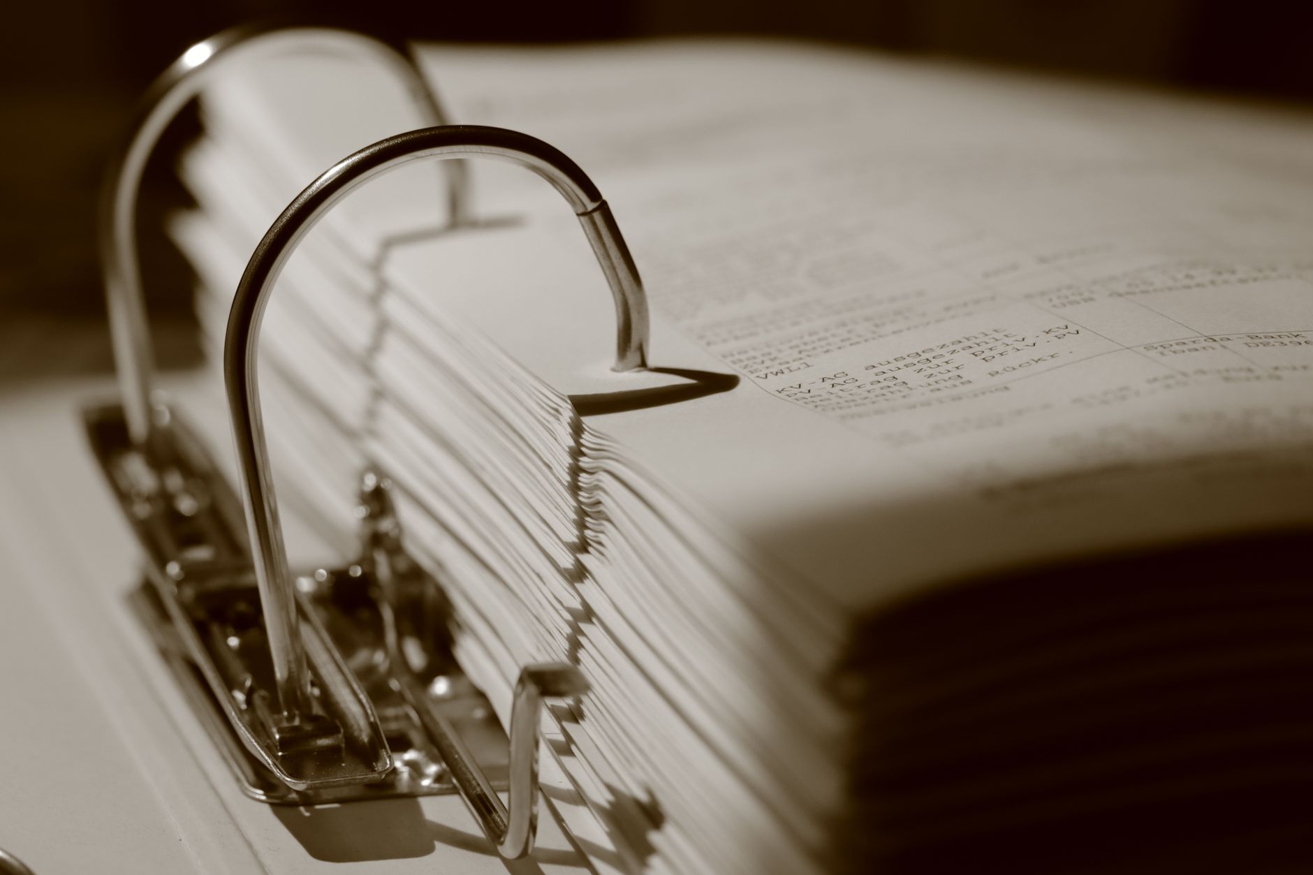 Financial documents and portfolio reports spread across an office desk