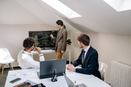 Interest Rate Collar Demand Is Quietly Hedging Corporate Debt Rollover Risk Corporate treasury team reviewing interest rate hedging strategy documents in a boardroom
