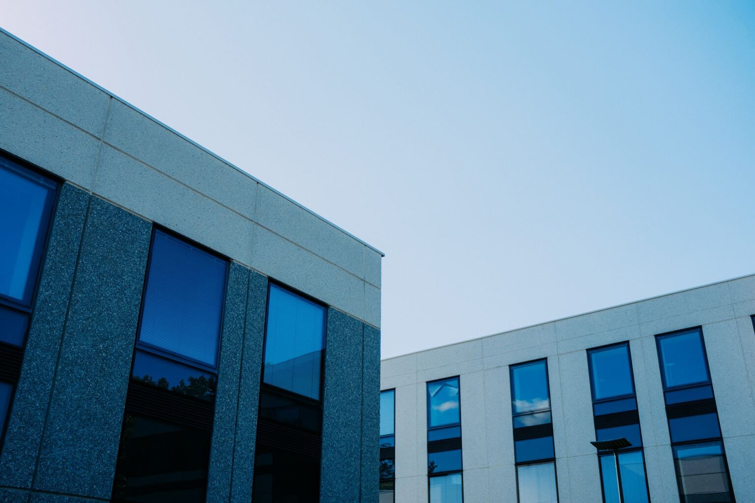 Credit Tenant Lease Securitization Is Quietly Straining Net Lease Valuations Aerial view of a large commercial property with a single-tenant building and parking lot