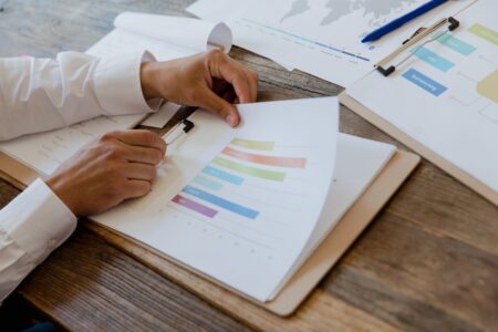 Payment-in-Kind Toggle Notes Are Quietly Straining Leveraged Credit Recoveries Financial documents and debt instruments spread across a desk representing leveraged credit analysis