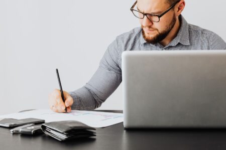 Financial documents and loan agreements spread across a desk representing structured credit analysis