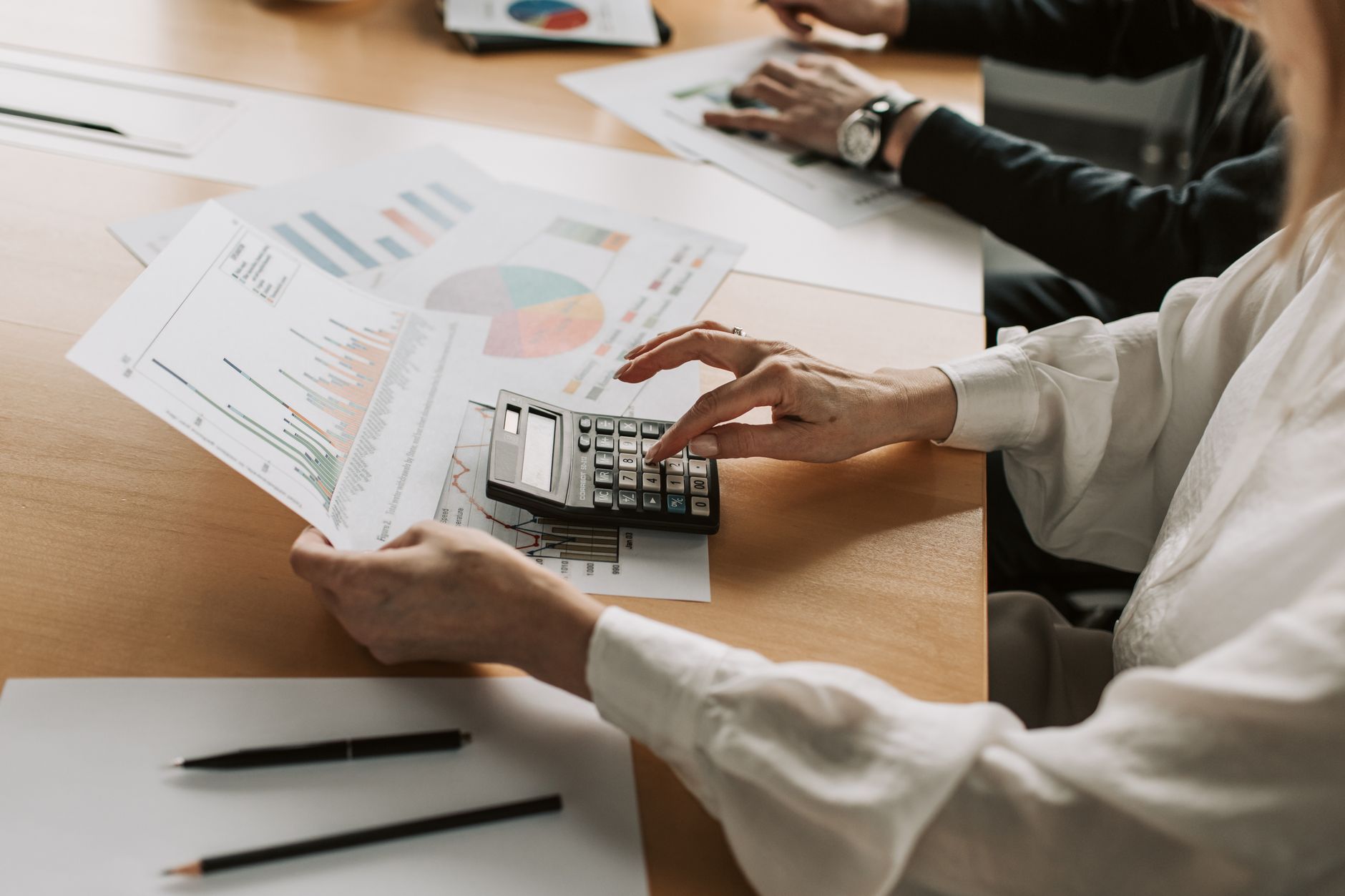 Portfolio managers reviewing credit documents at a conference table