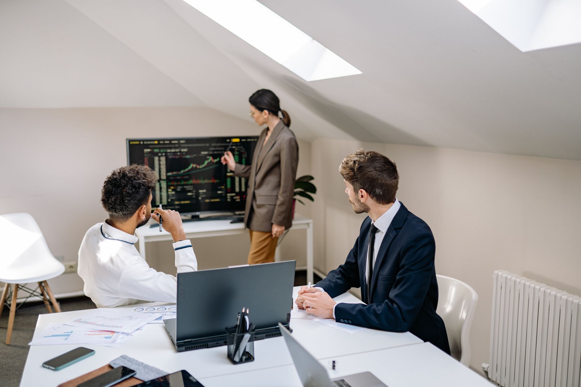 Financial professionals reviewing debt capital market documents in a conference room