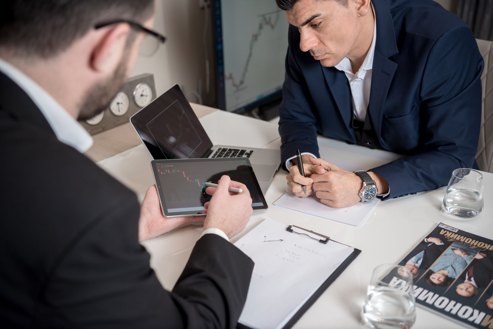 Finance professionals reviewing investment data during a meeting