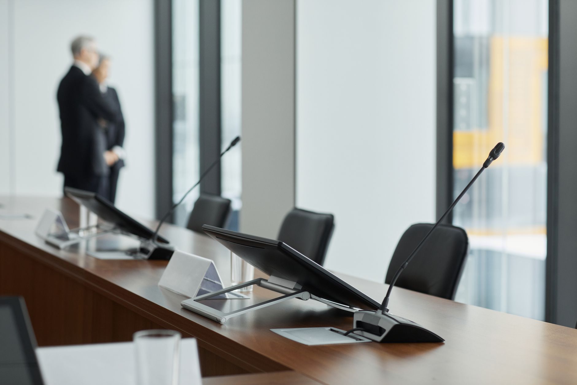 Business professionals in a boardroom reviewing structured finance portfolio performance data